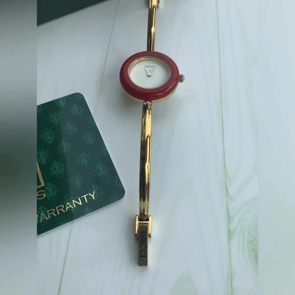 Gucci Women’s Gold Bangle Watch with Interchangeable Color Bezels